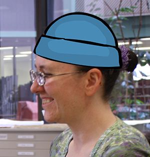 Side profile shot with cartoon blue beanie superimposed on head.